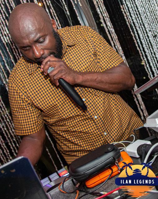 A performer singing at the DJ booth