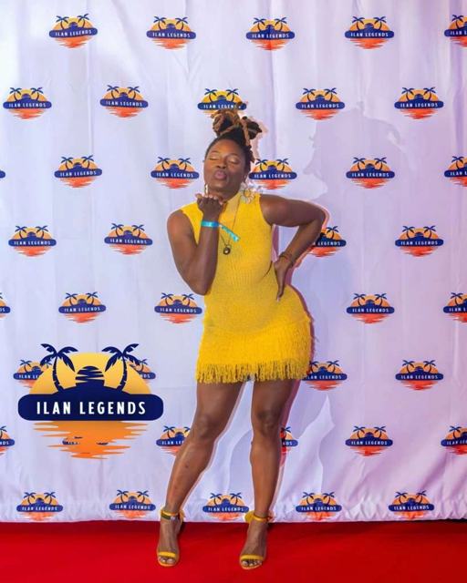 A guest in yellow on the red carpet