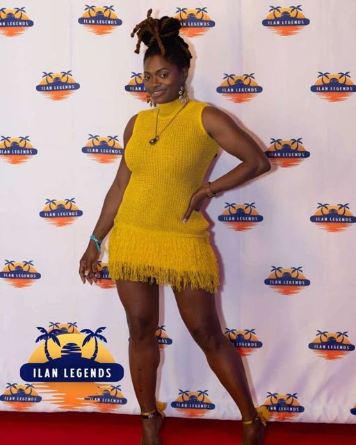 A guest in yellow on the red carpet