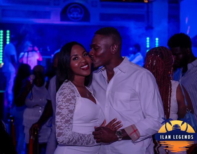 A couple smiling together in white